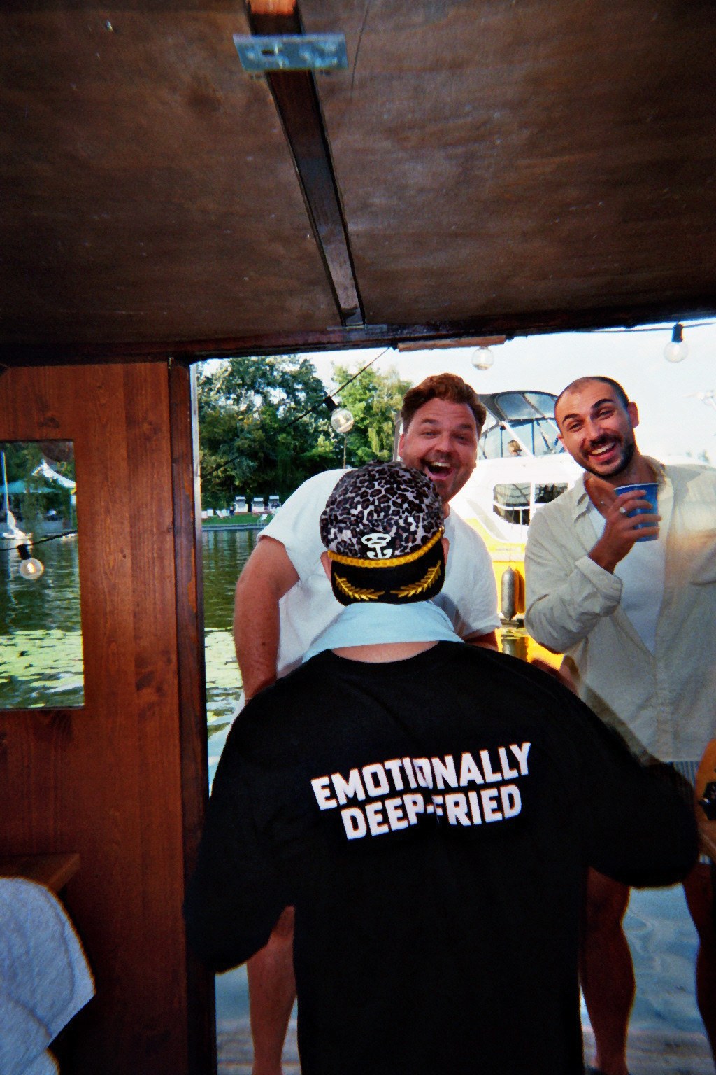 Colleagues toasting inside the boat cabin