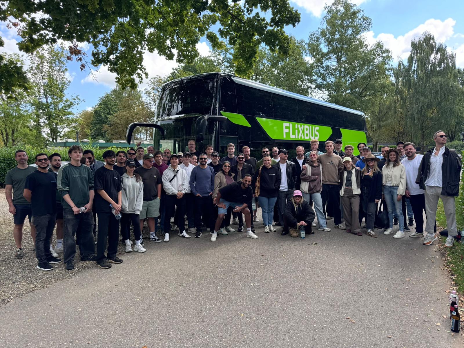 The whole team in front of the offsite bus