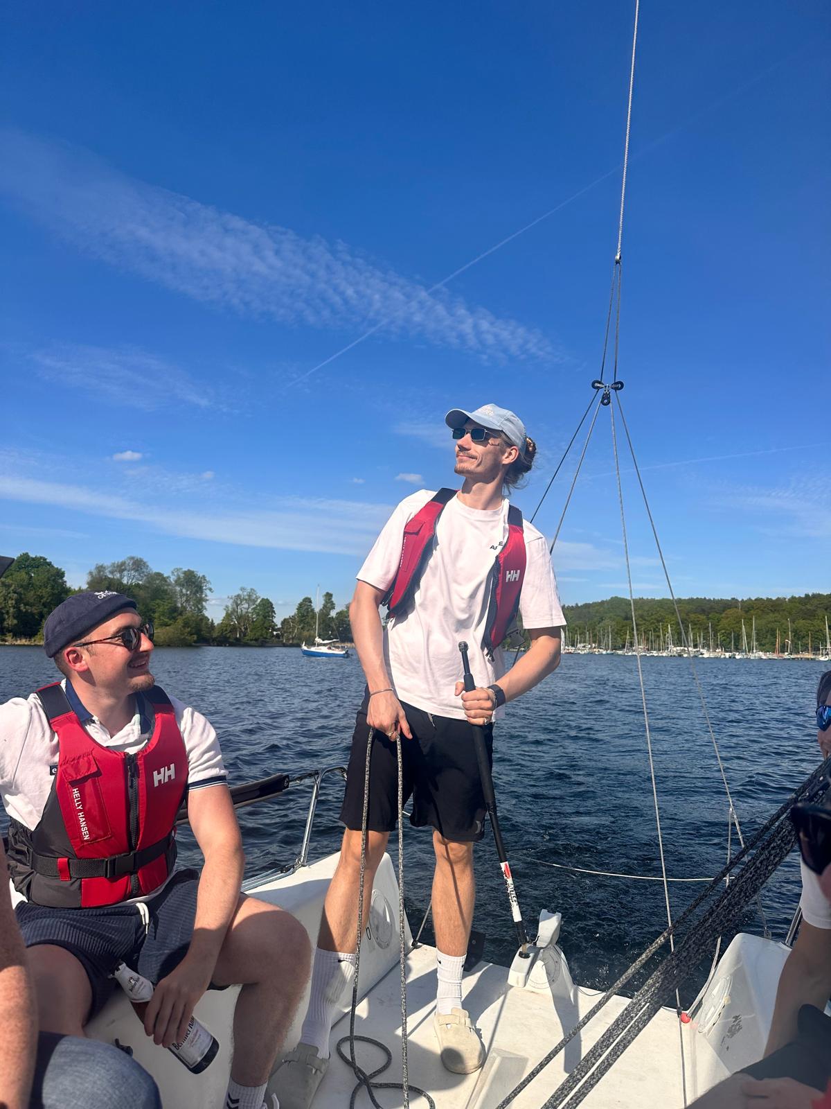 Team members sailing on a lake